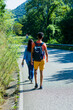 © Sangiao_Photography - Mid Couple walking on the road. Danger traffic safety education for tourism transportation.
