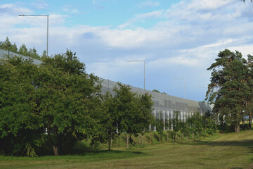 Wall Mural - Noise-protective road barrier, which is an outdoor structure designed to protect people from noise. View of the acoustic panels from the protected living area.