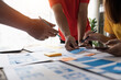 © Natee Meepian - Close up ux developer and ui designer brainstorming about mobile app interface wireframe design at modern office. Creative digital development agency