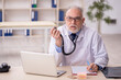 © Elnur - Old male doctor working in the clinic