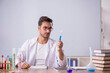 © Elnur - Young male chemist in front of white board