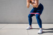 © Kaspars Grinvalds - Woman exercising outdoors with resistance band around thighs