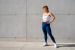 © Kaspars Grinvalds - Woman wearing sportswear of white sports bra and blue leggings