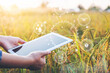 © joyfotoliakid - Smart farming Agricultural technology and organic agriculture Woman using the research tablet and studying the development of rice varieties in rice field