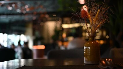 Wall Mural - Empty table at a dark restaurant with flowers