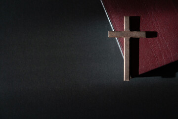 Wall Mural - Wooden crucifix cross on a leather cover bible. Top view, copy space.