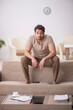 © Elnur - Young man sitting at home during pandemic