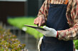 © Prathankarnpap - Cropped shot of farmer analyzing farming data on digital tablet at hydroponic greenhouse. Innovation technology concept