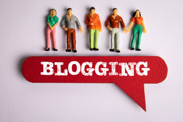Sticker - Blogging Concept. Red speech bubble with text and miniature figures of people on a white background
