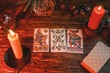 Reading a future by tarot cards on rustic wooden table. Three tarot cards from Marseille Tarot deck by unknown artist published first in 1709. Spanish Tarot deck.