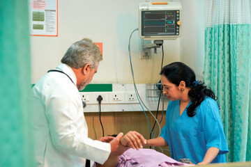 Wall Mural - Senior Doctor check up to patient on bed at hospital.