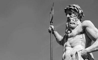 Wall Mural - Ancient statue of god of seas and oceans Neptune (Poseidon).  Black and white image. Copy space for text or design.