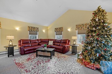 Poster - Interior design on a beautiful home with a red sofa and a Christmas tree