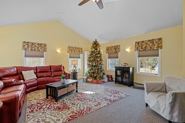 Sticker - Interior design on a beautiful home with a red sofa and a Christmas tree