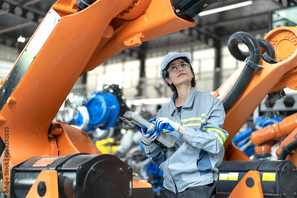 Female industrial engineer maintenance mechanic orange robot frame then ...
