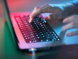 © Westend61 - Hacker working on illuminated laptop at office