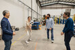 © Westend61 - Happy engineers playing volleyball with soccer ball in industry