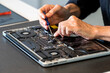 © Westend61 - Man repairing laptop with screwdriver