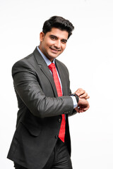 Wall Mural - Young indian businessman in classic suit giving expression on white background.