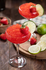 Wall Mural - Frozen strawberry daiquiri cocktail with strawberries and lime