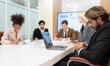 © Wosunan - In the meeting room of an international business corporation, a diverse group of young entrepreneurs are enthusiastically taking their ideas and sharing perspectives.