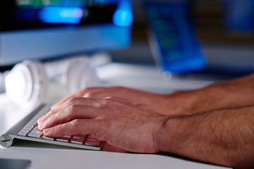 Wall Mural - Focus on hands of senior IT manager pressing keys of computer keyboard while sitting by workplace and networking or decoding data