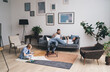 © BullRun - Family spending time in living room at home