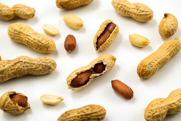 Wall Mural - Dried peanuts in closeup on white