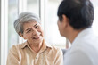 © SKW - Asian couple, elderly man and woman sitting on the sofa having fun chatting together at home. Concept: health insurance, life insurance, retirement happiness.