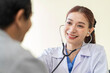 © SKW - Asian doctor talking to patient with smile to encourage patients at the hospital