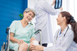 © SKW - A doctor is caring for an elderly female patient at a hospital where she has undergone knee surgery. This made her need to use a wheelchair instead of walking and have a doctor take care of it closely