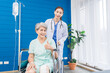 © SKW - A doctor is caring for an elderly female patient at a hospital where she has undergone knee surgery. This made her need to use a wheelchair instead of walking and have a doctor take care of it closely