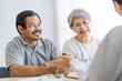© SKW - Asian seniors who are healthy, in a good mood, smiling, talking with financial or life insurance staff to take care of life after retirement.