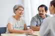 © SKW - Asian seniors who are healthy, in a good mood, smiling, talking with financial or life insurance staff to take care of life after retirement.