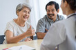 © SKW - Asian seniors who are healthy, in a good mood, smiling, talking with financial or life insurance staff to take care of life after retirement.