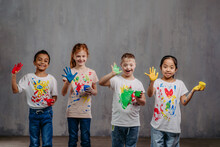 Portrait Of Happy Kids With Finger Colours And Painted T-shirts, Studio Shoot.