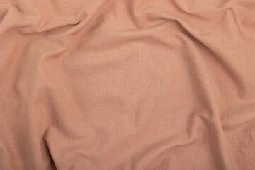 Brown fabric texture. Fabric background with a fold.