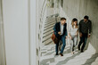 © BGStock72 - Group of corporate business professionals climbing at stairs in office corridor