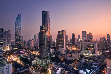 Wall Mural - Night view of urban skyline at dusk. Downtown with skyscrapers and modern architecture. Bangkok, Thailand...