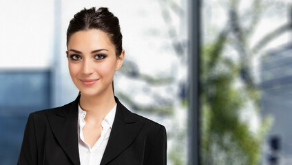 Wall Mural - Smiling businesswoman portrait in a modern office