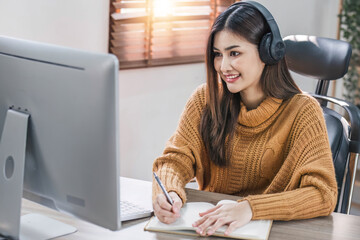 Wall Mural - Asian girl student online learning class study online video call zoom teacher, Happy asian girl learn english language online with computer laptop..