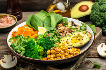 Sticker - Green vegetable vegan salad with avocado, mushrooms, broccoli, spinach, chickpeas, pumpkin. Healthy vegetarian food concept. top view