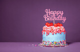 Fototapeta Tęcza - Fun happy birthday drip cake over a purple background