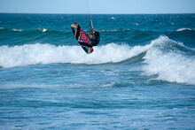 Several Colorful Kitesurfers Sailing In A Rough Sea With A Lot Of Wind