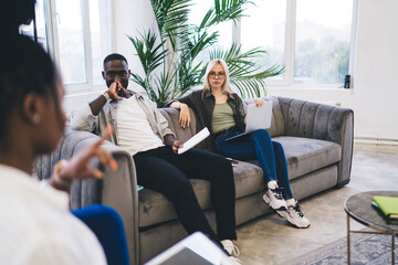 Sticker - Positive coworkers working on design project in loft style office