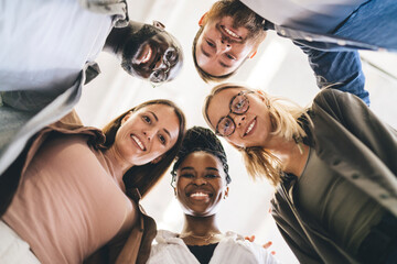 Wall Mural - Cheerful diverse coworkers laughing in office room