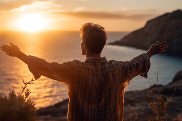 Wall Mural - Young man arms outstretched by the sea at sunrise or sunset enjoying freedom and life - Ai generative