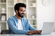 © Prostock-studio - Handsome Indian Male Freelancer Using Laptop Computer While Working In Home Office
