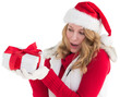 Surprised blonde in santa hat holding gift