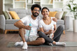 © Prostock-studio - Sporty indian couple exercising together at home and posing at camera
